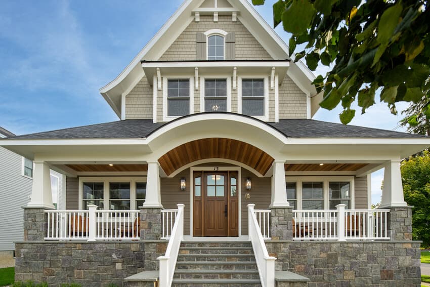 James Hardie shingle-style craftsman home with a stone base